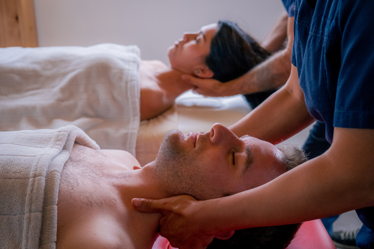 couple massaged, by two masseurs, doing cervical and neck massage
